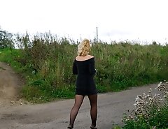 Stockinged blonde makes water on a quiet park alley
