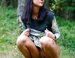 Spying after a brunette kitty pissing in the woods