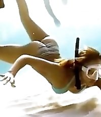 Alba dives in bikini & dances in fishnets