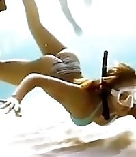 Alba dives in bikini & dances in fishnets