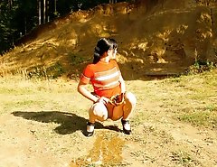Cute tart walking down the hill squats down to pee