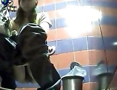 Two babes pissing in a spycammed beach toilet