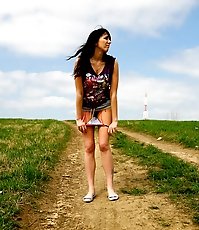 Emo chick pissing in the middle of a country road