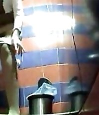 Two babes pissing in a spycammed public toilet