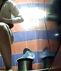 Two babes pissing in a spycammed public toilet