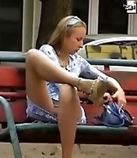 Voyeur upskirt pussy of blonde amateur playing with a phone
