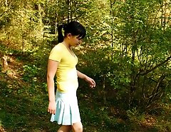 Cute brunette squats down to take a leak in forest