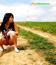 Emo chick pissing in the middle of a country road