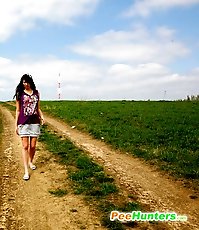 Emo chick pissing in the middle of a country road