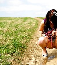 Emo chick pissing in the middle of a country road