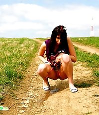 Emo chick pissing in the middle of a country road