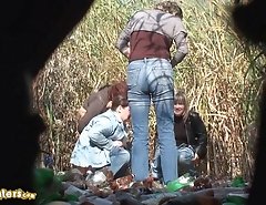 Four women pissing and chatting outdoors