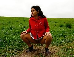 Girlie feeling cold takes a quick leak on a field